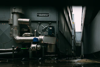 a large metal pipe next to a building