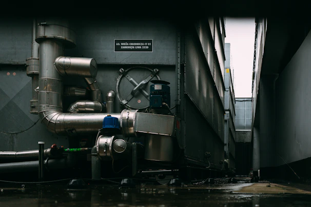 a large metal pipe next to a building