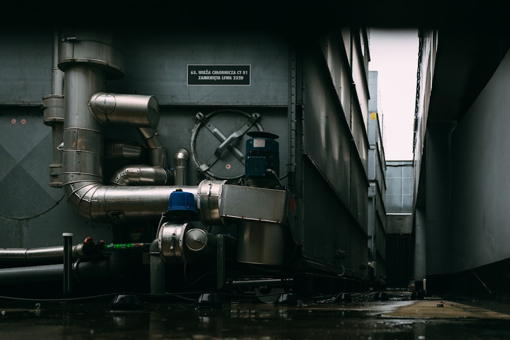 a large metal pipe next to a building