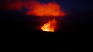 A dramatic night scene with lava flows illuminating a battle site from a notable 2b2t event.