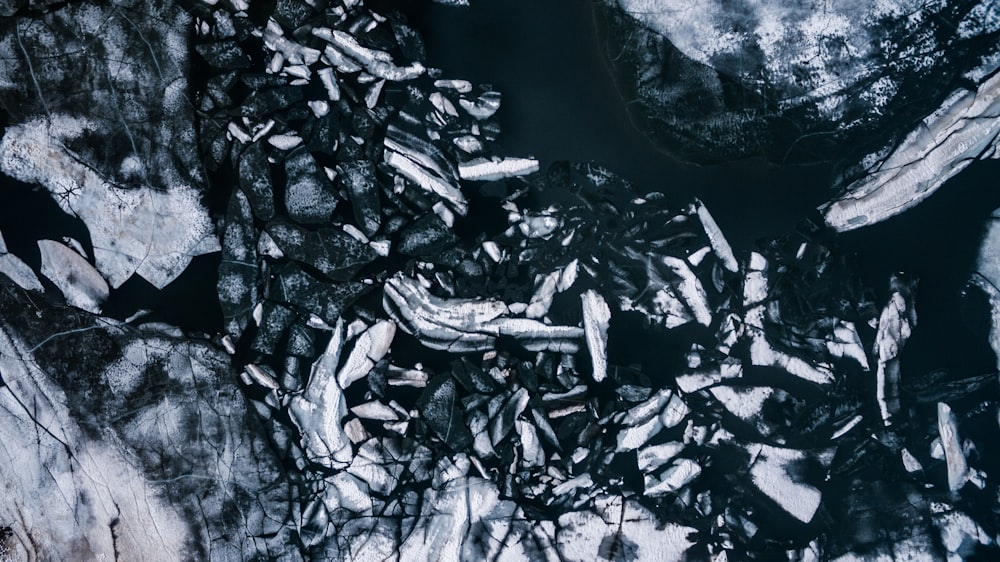 a black and white photo of rocks and water