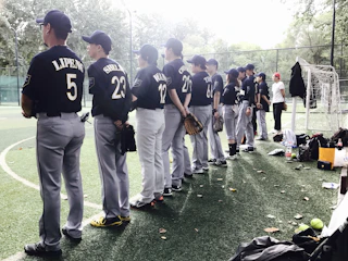 Volunteers distributing baseball equipment to children in need.