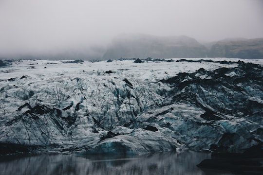 calm body of water beside the mountain in Mýrdalsjökull Iceland