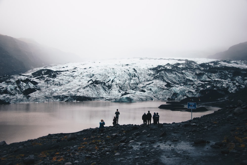 people beside body of water