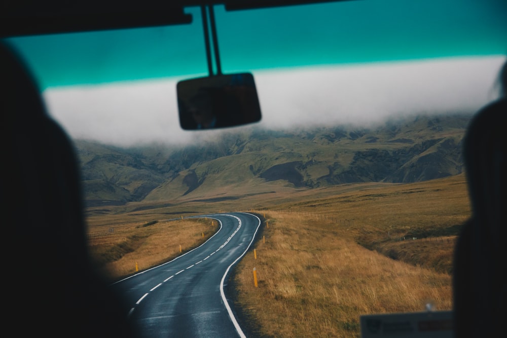 concrete road leading to green mountain