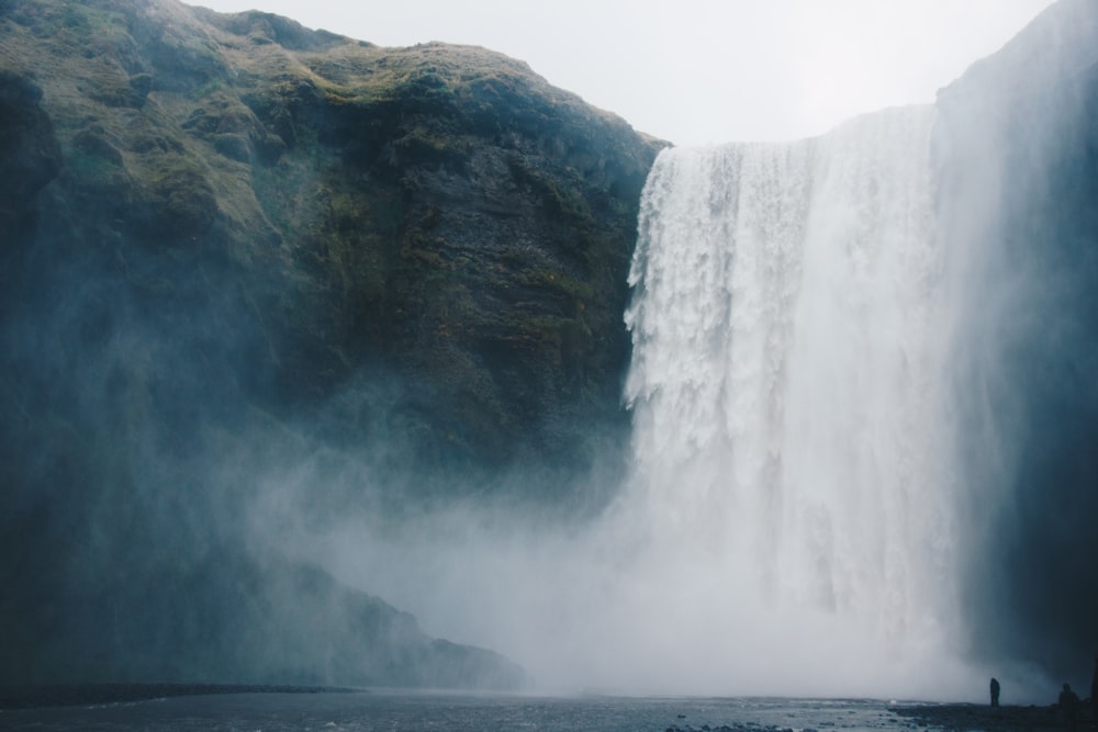 photo of waterfall under clear sky