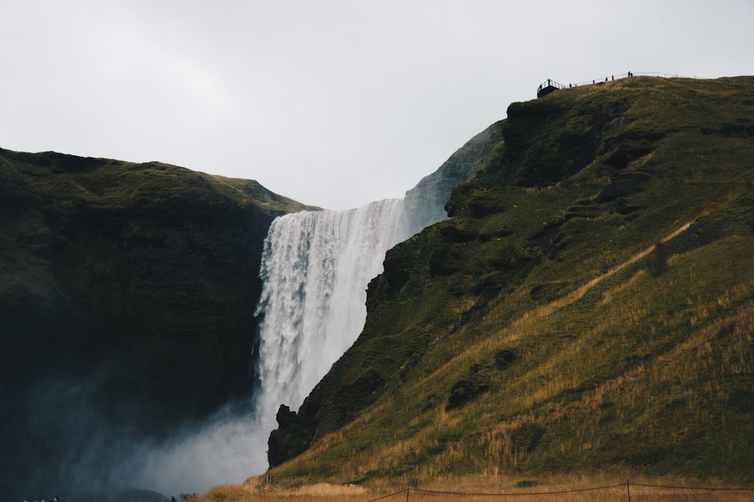 landscape photography of water falls and mountains