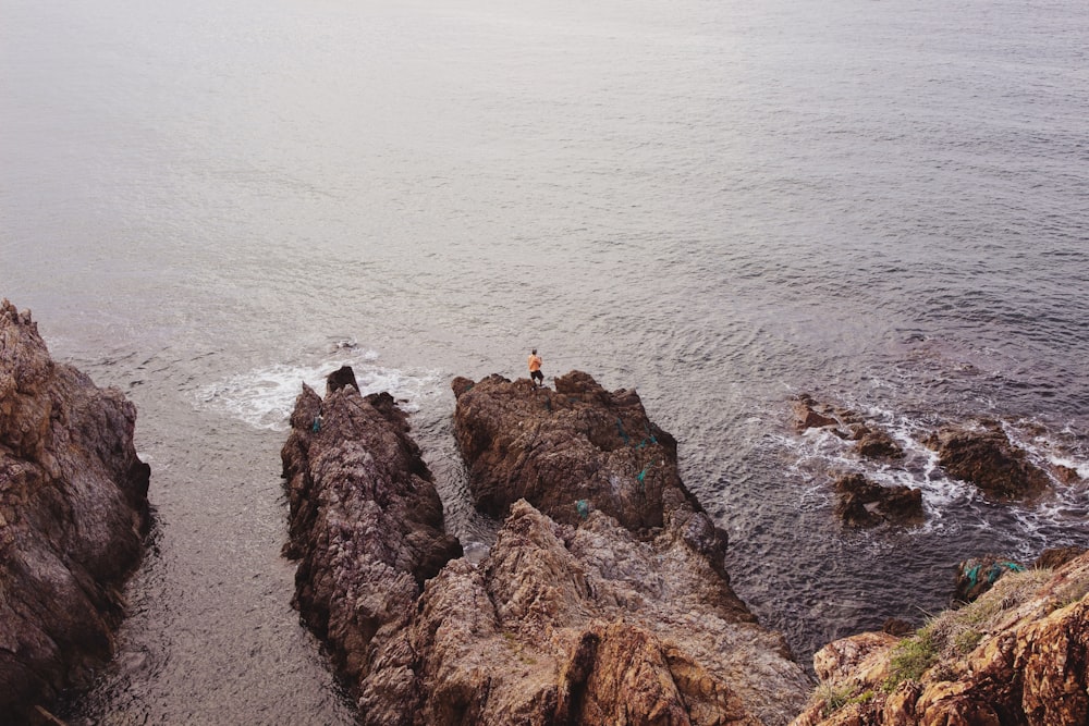 man standing near body of water during daytime