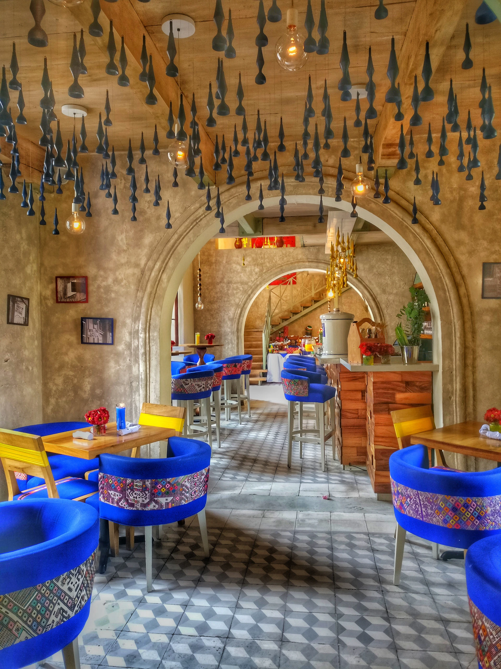 A vibrant shot of Broncos Café's lively interior, featuring orange and blue décor with football memorabilia and fans enjoying coffee.