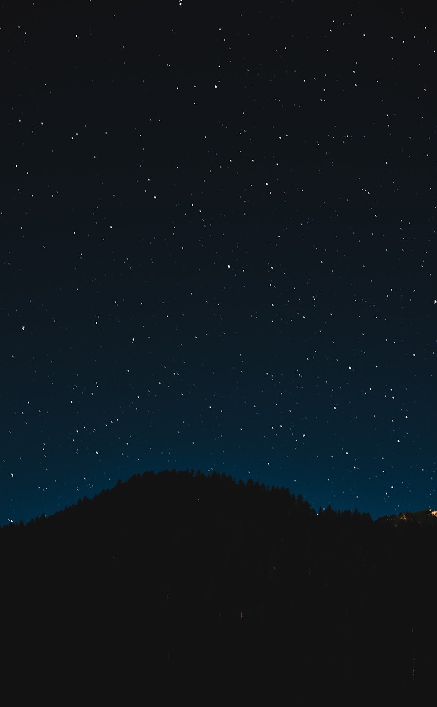 Bioluminescent plankton glowing blue in the ocean waves at night in the Maldives