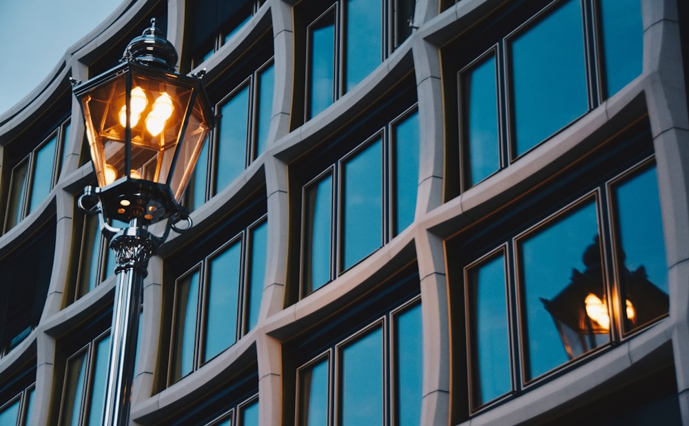 close-up photo of turned on black post lamp