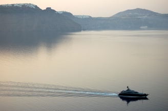 Captain navigating a yacht smoothly through calm coastal waters.