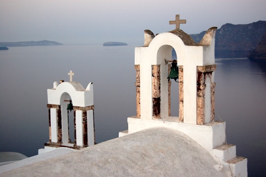 white and brow church roof during daytime in Santorini Greece