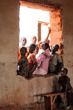 children sitting on window