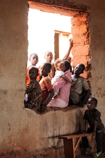 children sitting on window