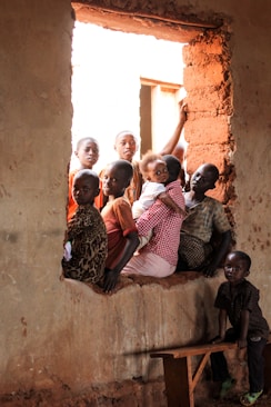 children sitting on window
