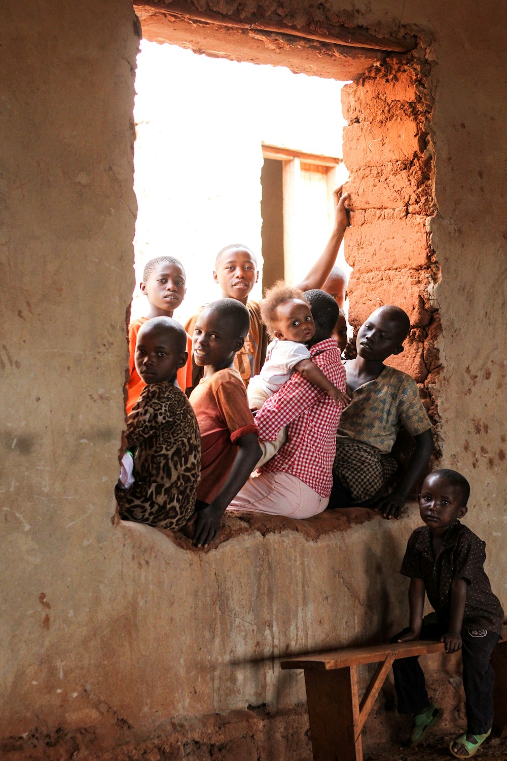 children sitting on window