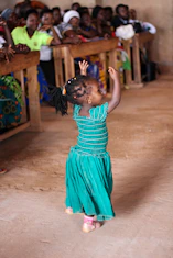 Children happily performing in a colorful dance studio