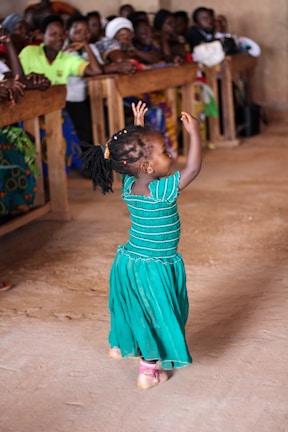 Children joyfully dancing in traditional African attire during a community event in Münster.