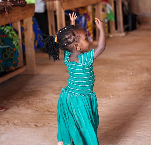 people watching dancing girl wearing blue dress