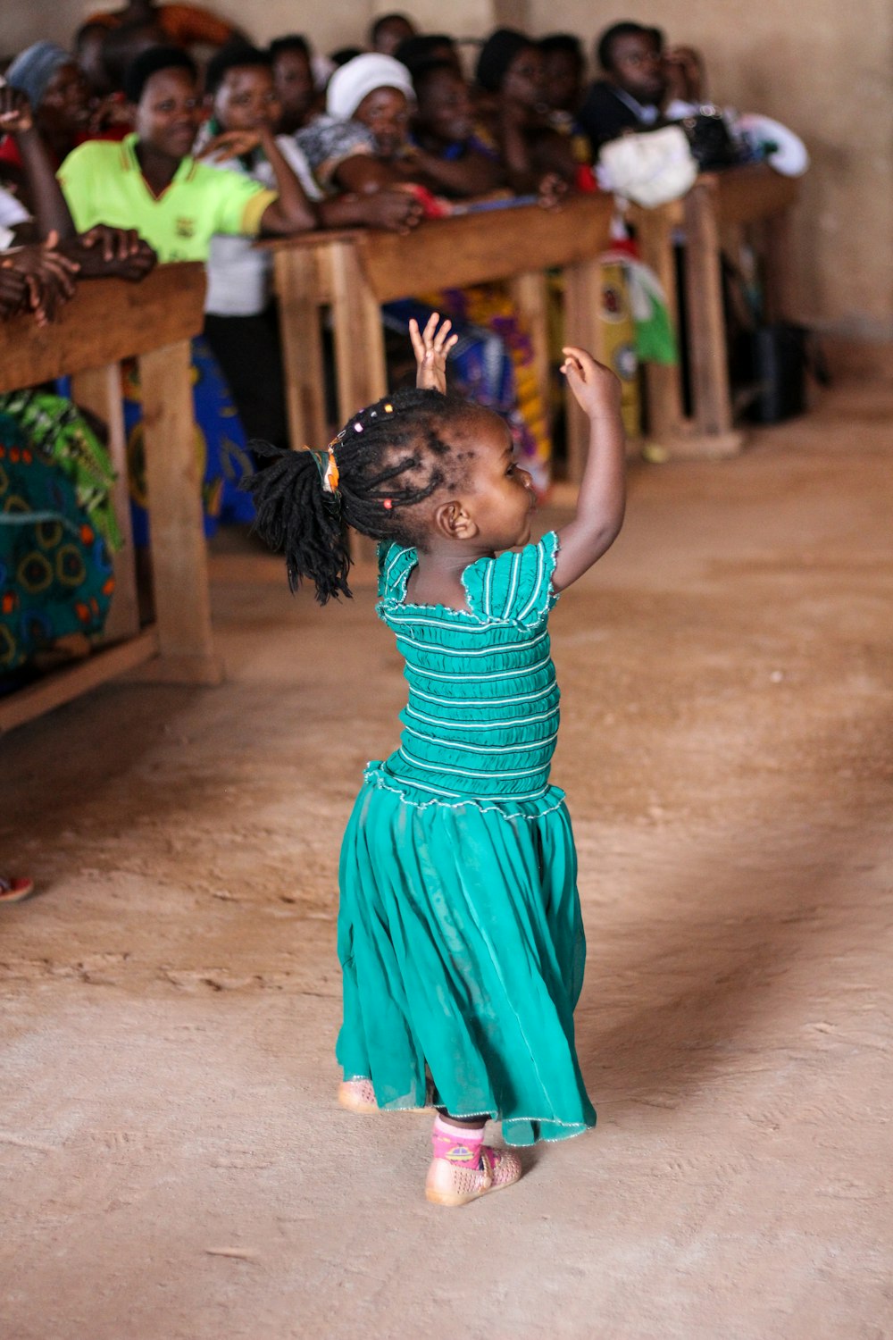 people watching dancing girl wearing blue dress