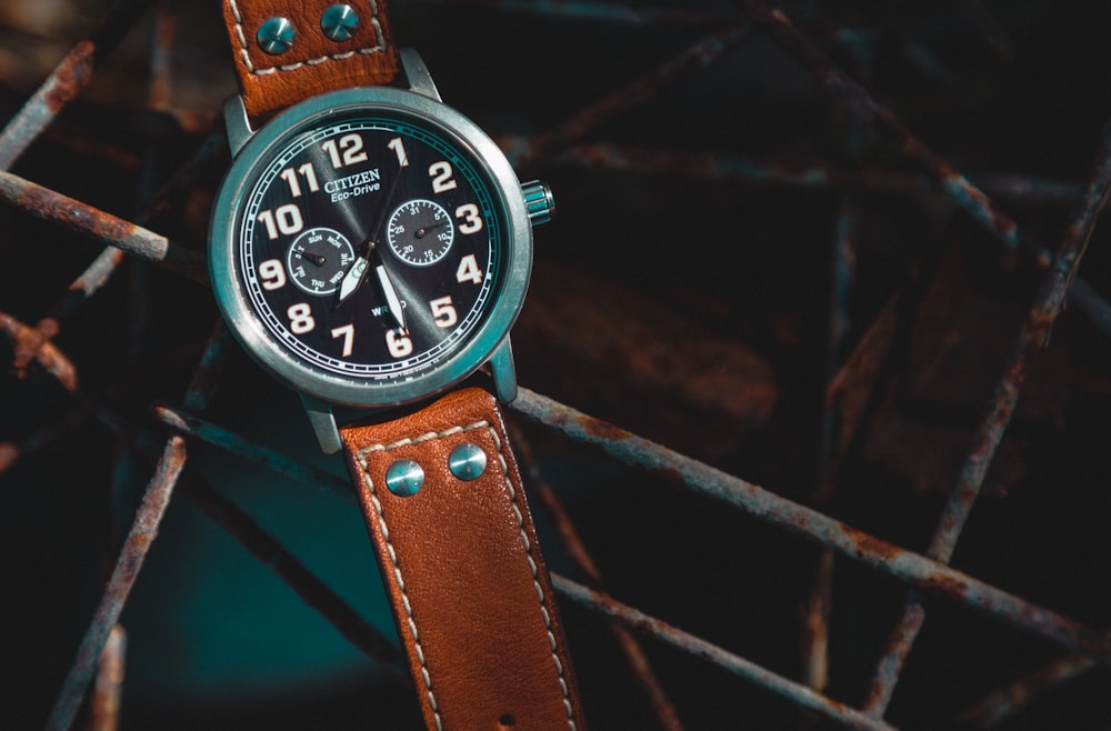 round black Citizen chronograph watch with brown leather strap