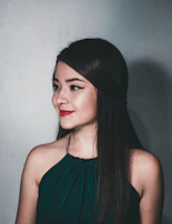 Professional portrait of a young woman in a sleek outfit against a minimalist backdrop.