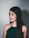 Portrait of a confident young woman with a sleek dark background and subtle gold lighting accents.