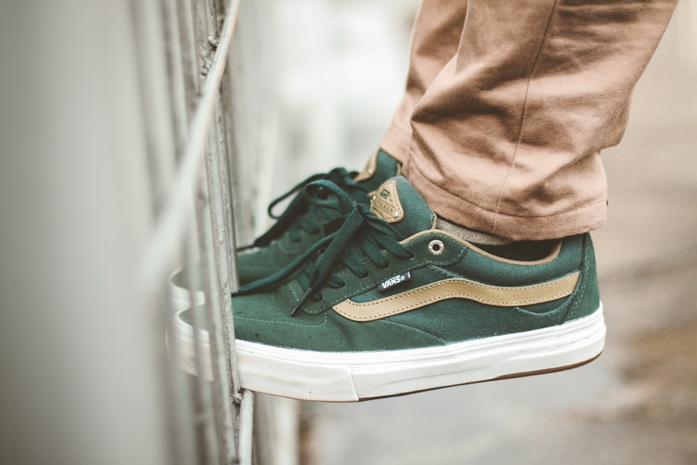 person wearing green Vans low-top sneakers