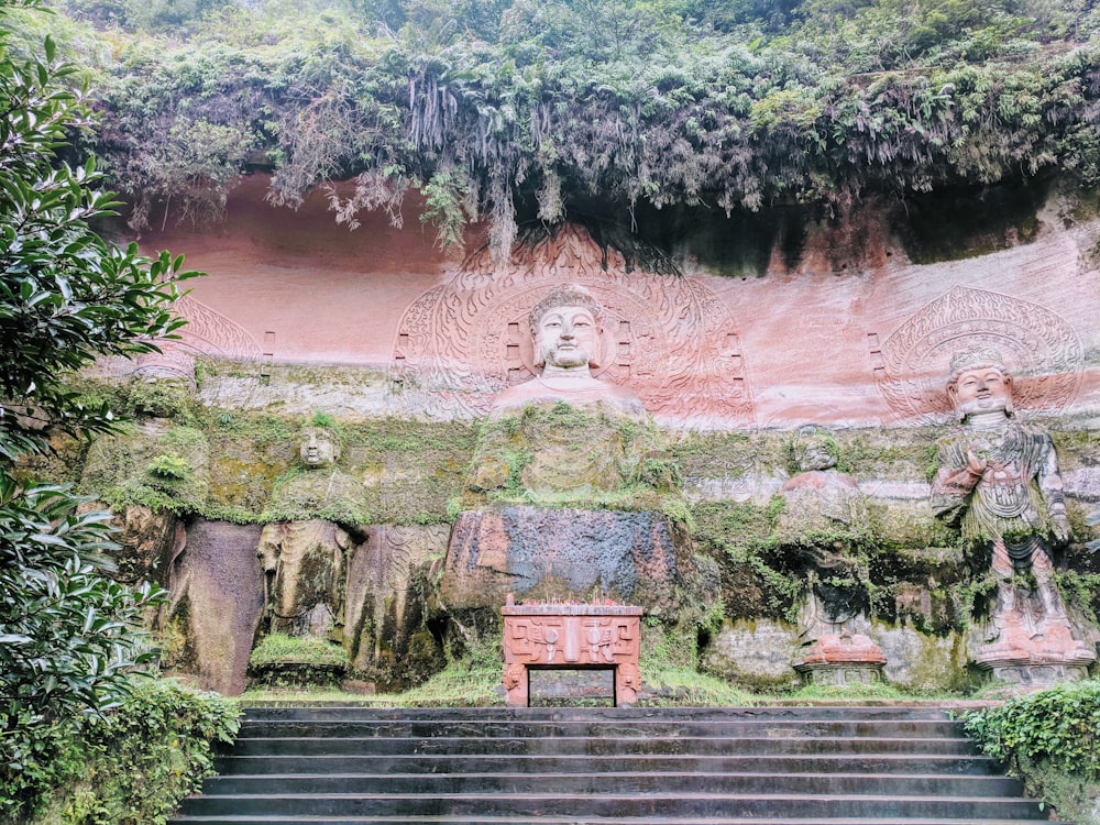 brown and green statue near trees