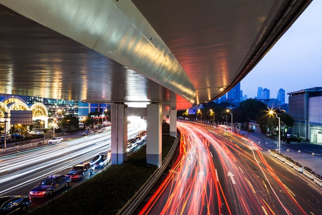 Close-up of a vibrant LED traffic light installed on a busy city street at dusk