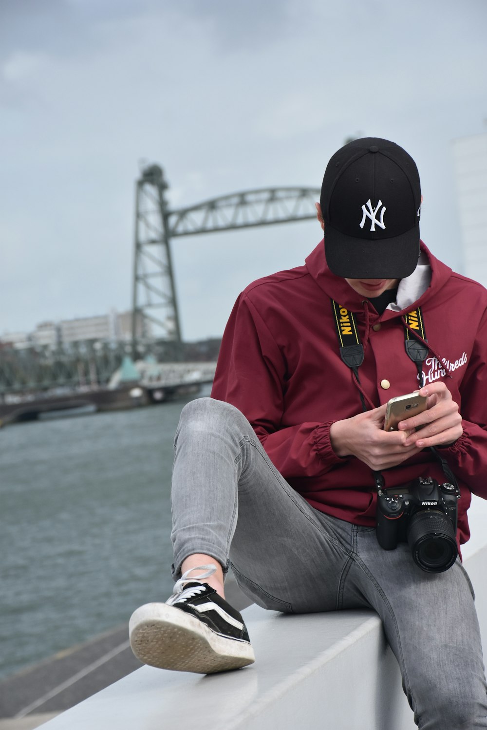 selective focus photography of sitting man using iPhone