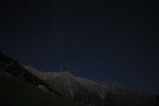 brown mountain under starry night during night time in Triund India