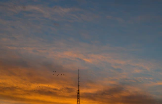 Sunset view outside the radio station with Javanese motifs subtly visible on the building walls.
