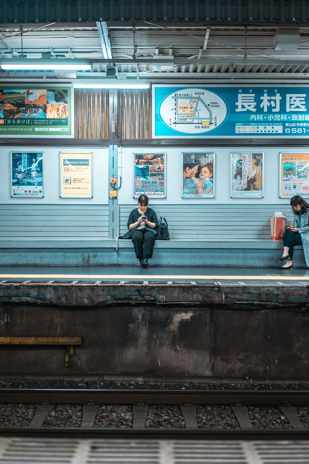 woman sitting on bench while using phone