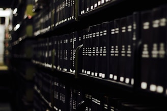 black hardbound books on shelves