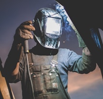 man wearing automatic dark welding helmet