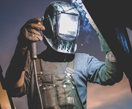 man wearing automatic dark welding helmet