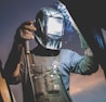 man wearing automatic dark welding helmet