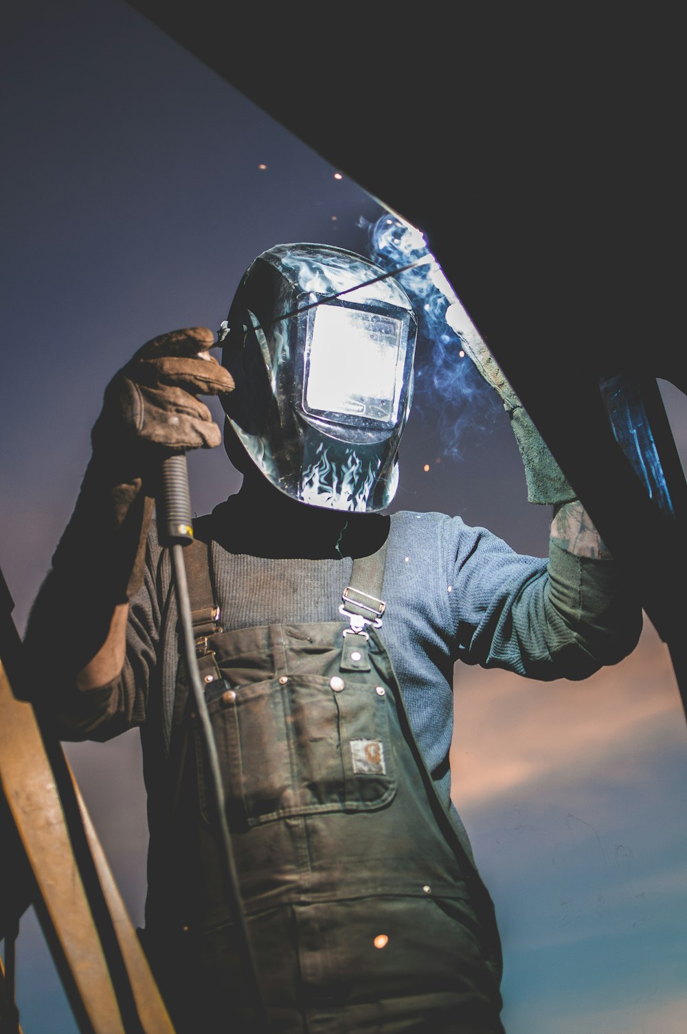 man wearing automatic dark welding helmet