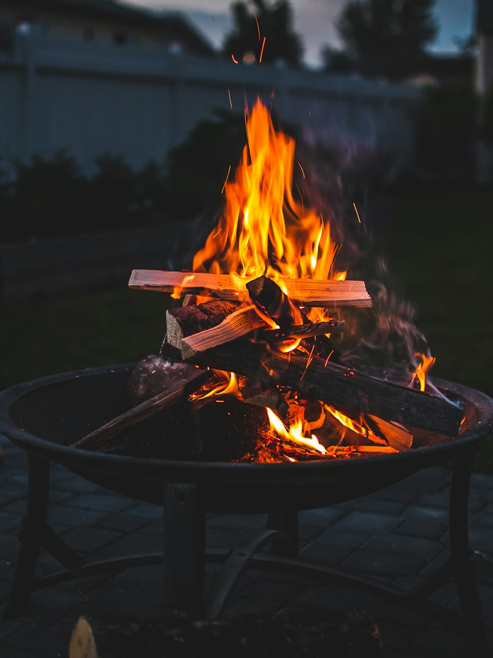 Lagerfeuer auf brauner Stahlfeuerstelle während des Sonnenuntergangs