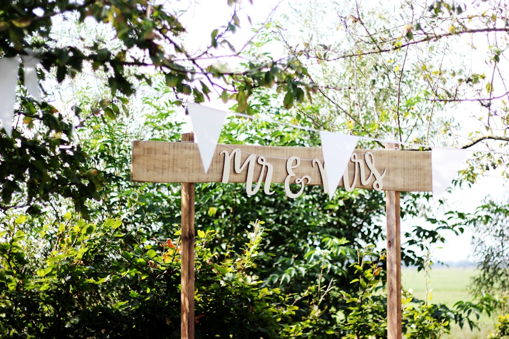 beige Mr & Mrs wooden sign during daytime