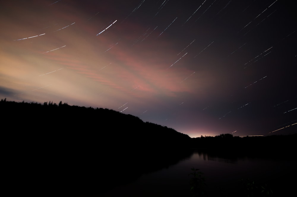 silhouette of mountain with light peaking