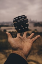 person holding camera lens