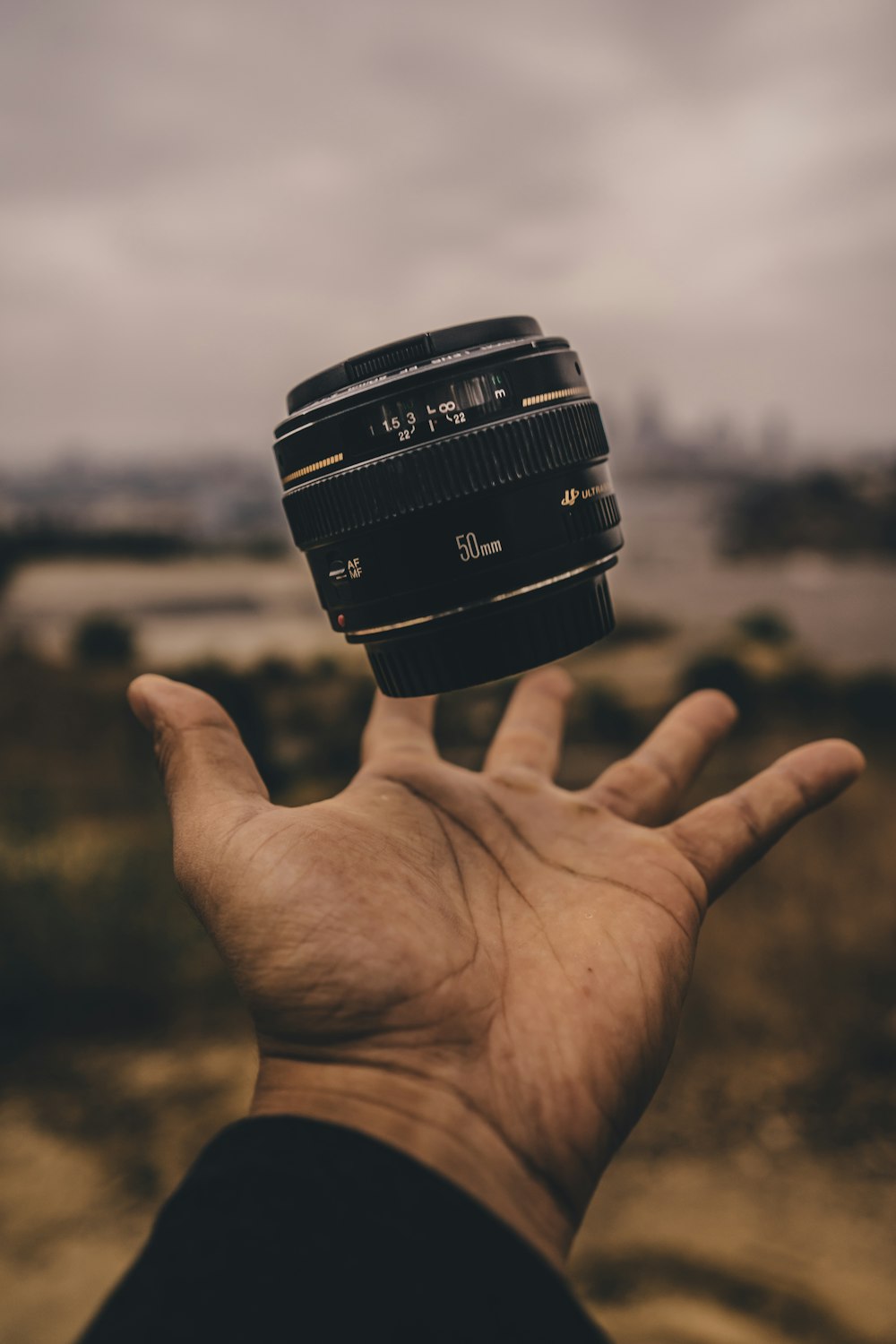 person holding camera lens