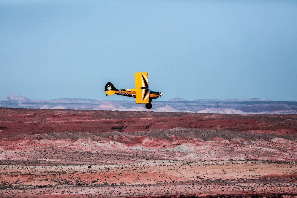 yellow and black mono plane at flight