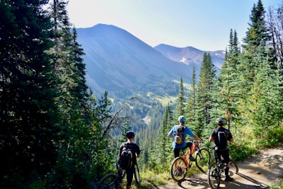 three person riding on bicycles during daytime