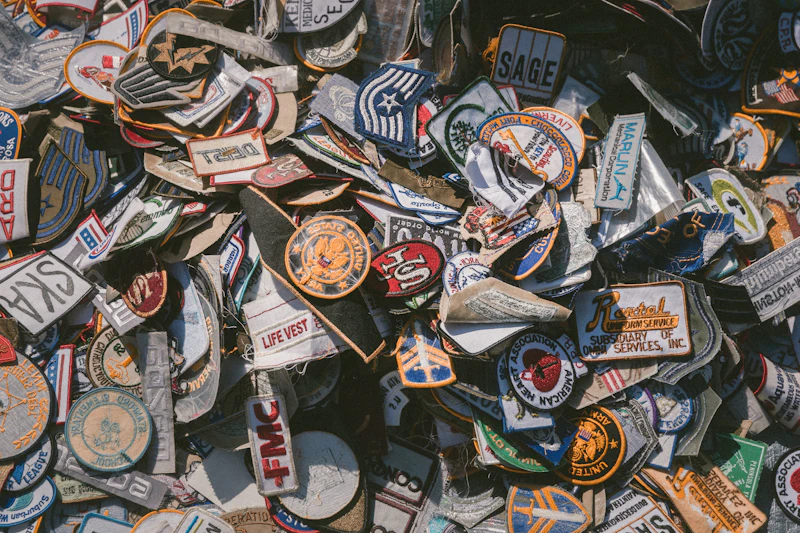 Dozens of colourful embroidered crest patches arranged edge to edge