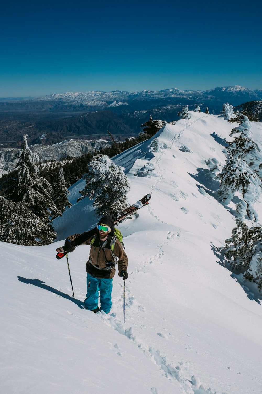 person standing on snow covered mountain