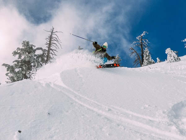 Skier carving through deep powder on snowy mountain